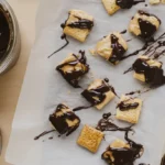 Featured image of best recipe for cheez it peanut butter and chocolate, half-dipped in melted chocolate, with peanut butter and Cheez-Its nearby