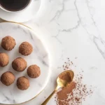 A plate of homemade truffle chocolate rolled in cocoa powder