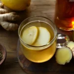 Brazilian Mounjaro Recipe with Apple Cider Vinegar in a glass mug with lemon and ginger, placed on a rustic wooden surface